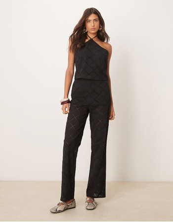 halter neck crop top and trousers co-ord with geo cutwork in black