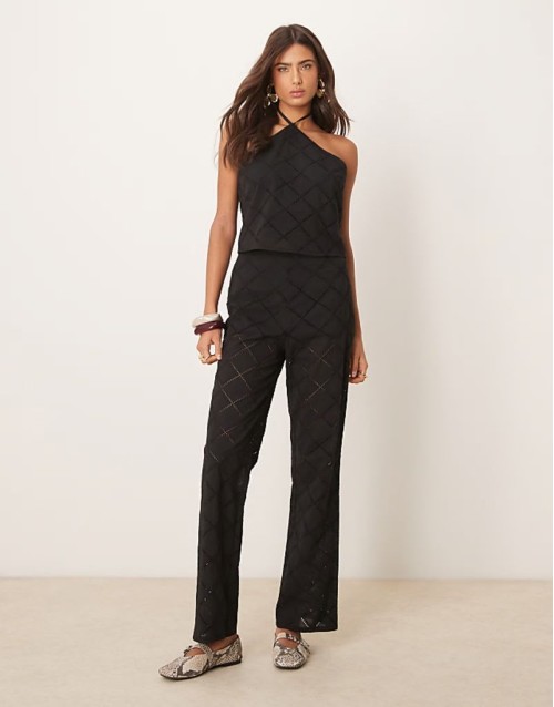 halter neck crop top and trousers co-ord with geo cutwork in black
