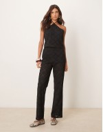 halter neck crop top and trousers co-ord with geo cutwork in black